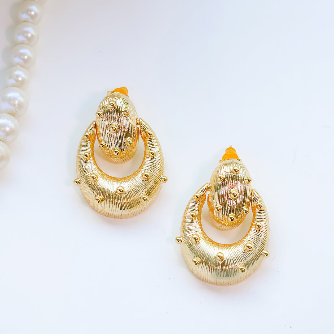 Gold earrings on a white background