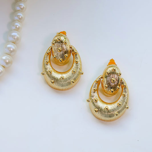Gold earrings on a white background