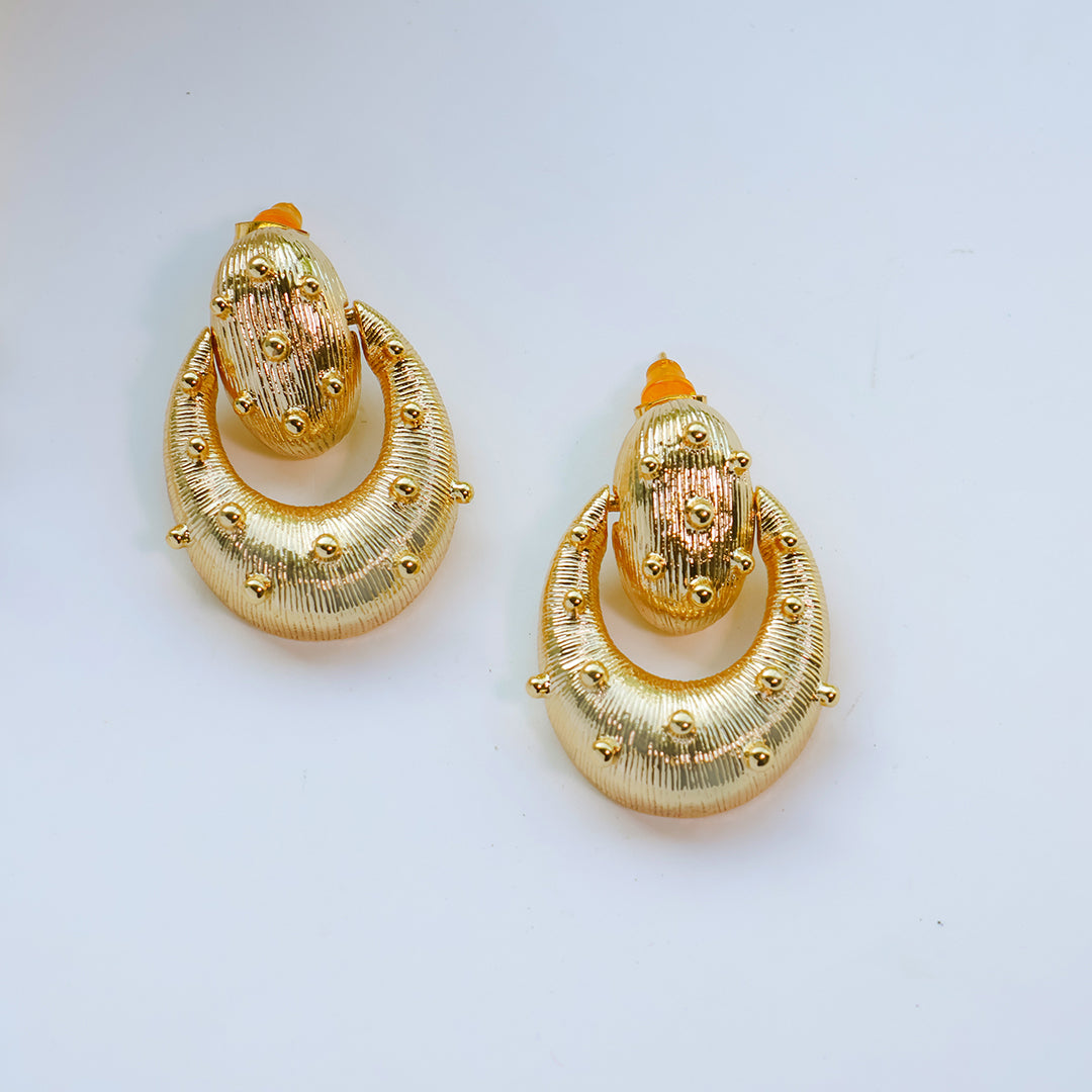 Pair of gold earrings on a white background