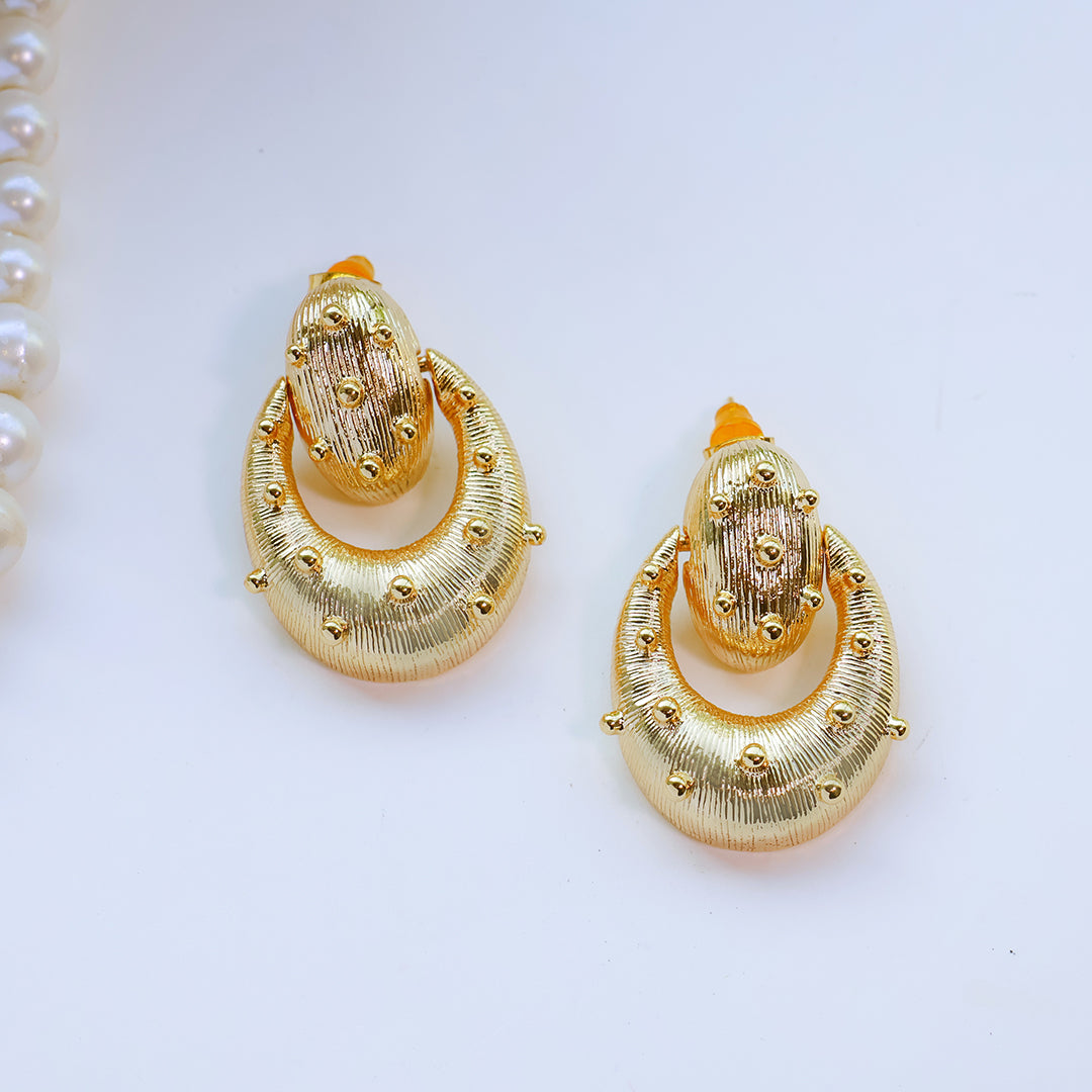 Gold earrings on a white background
