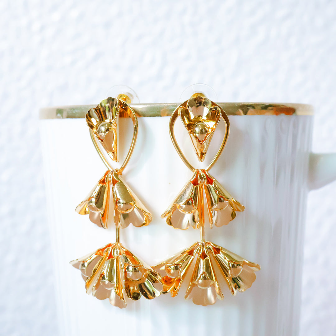 Gold earrings on a white background