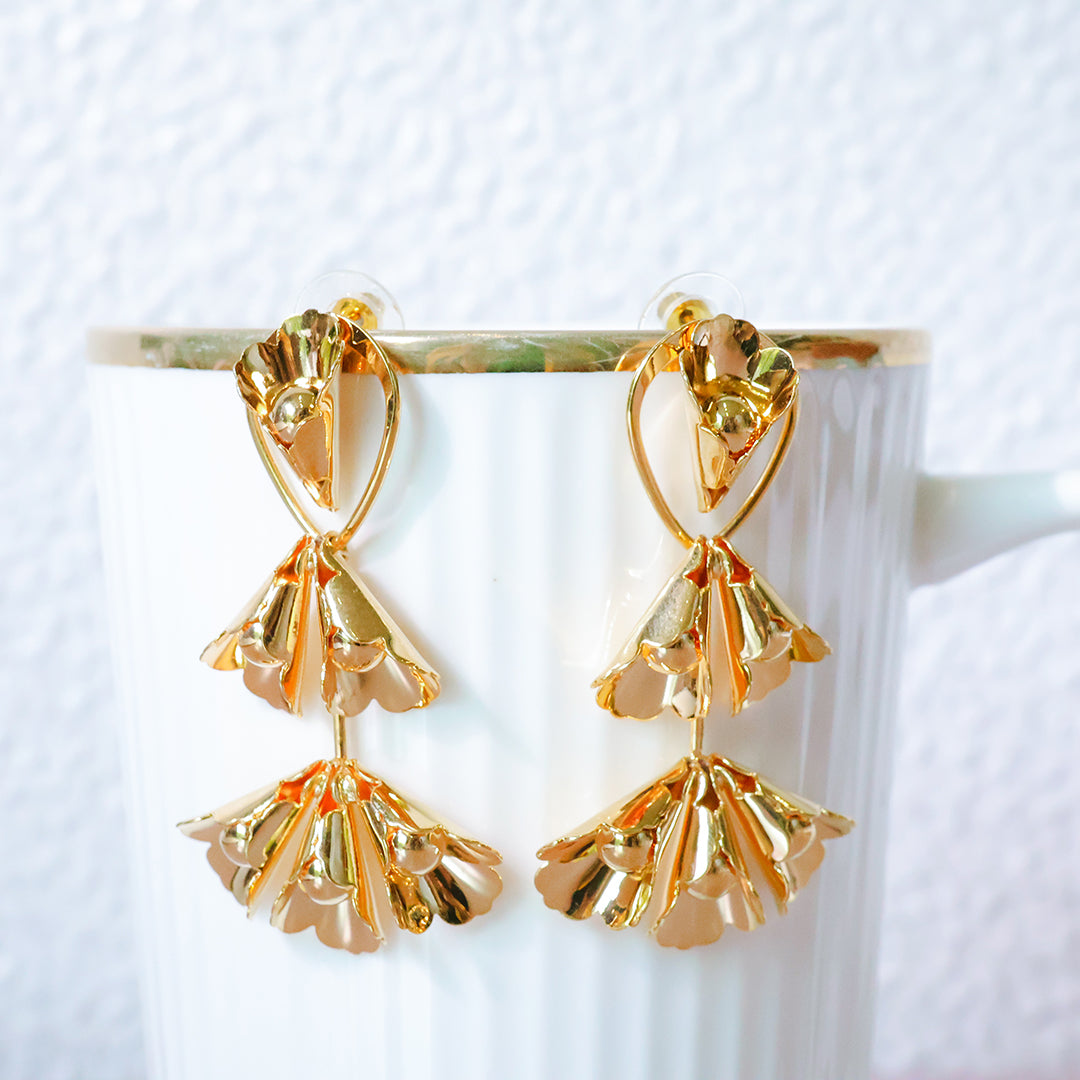 Gold earrings on a white background