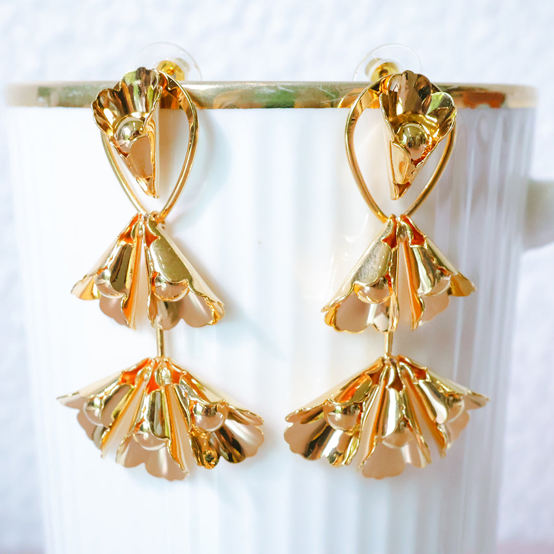 Gold earrings on a white background