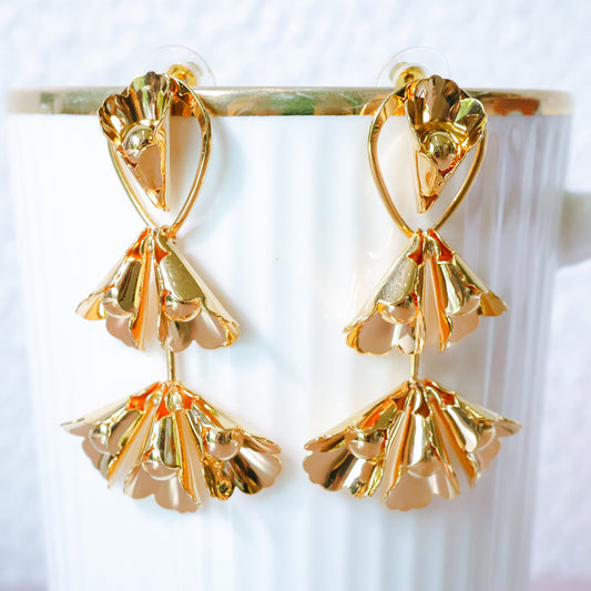 Gold earrings on a white background