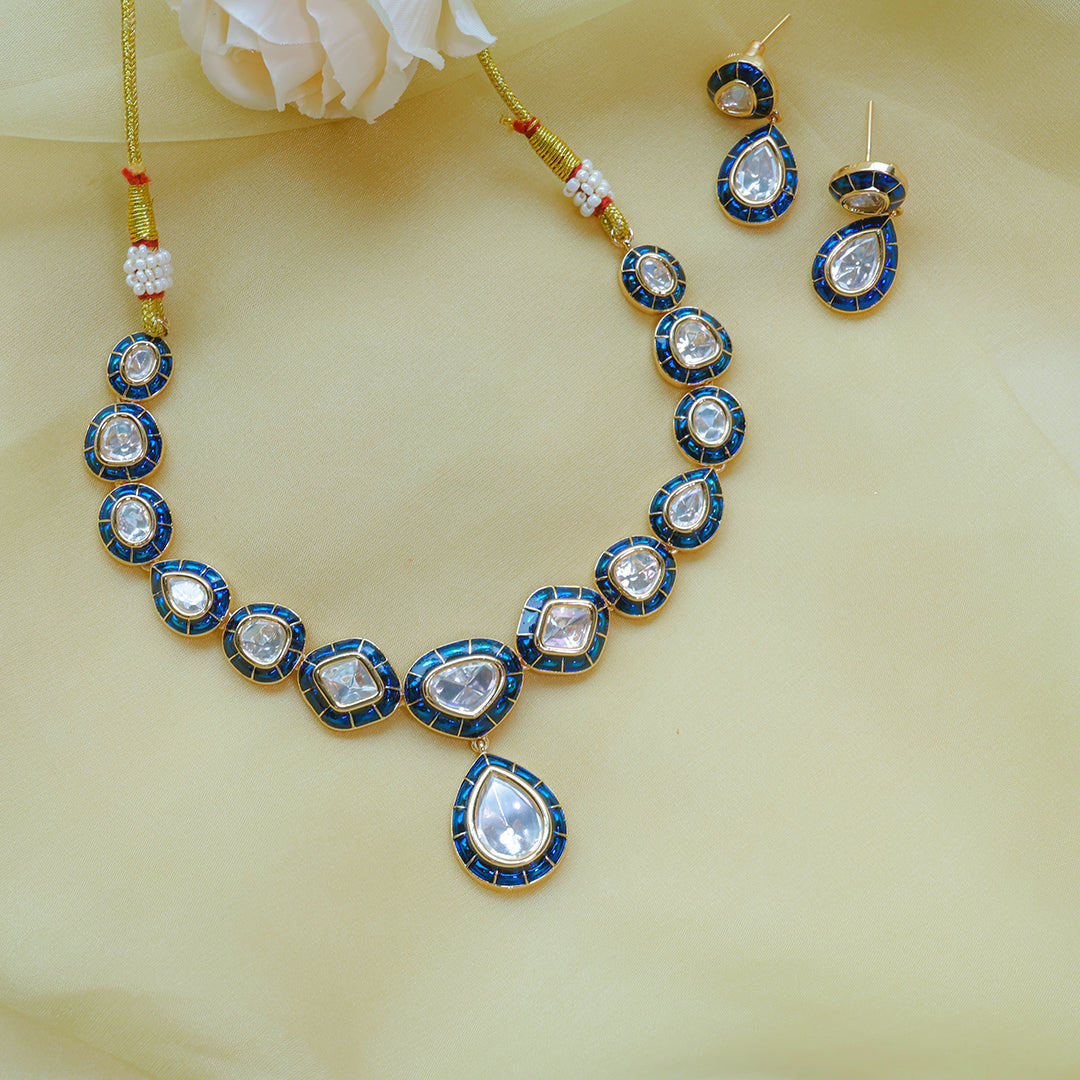Jewelry set with necklace, earrings, and bangles on a light yellow background