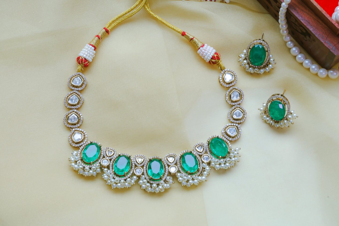 Jewelry set with necklace and earrings on a beige background