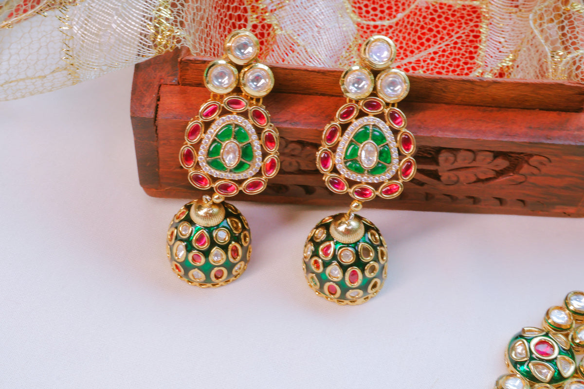 Decorative earrings with green, red, and gold colors on a white background