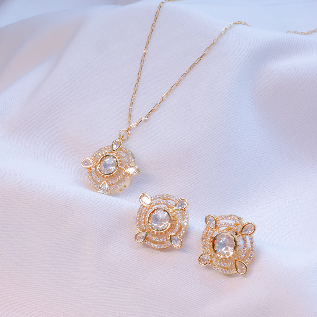 Gold jewelry set with necklace and earrings on a white background