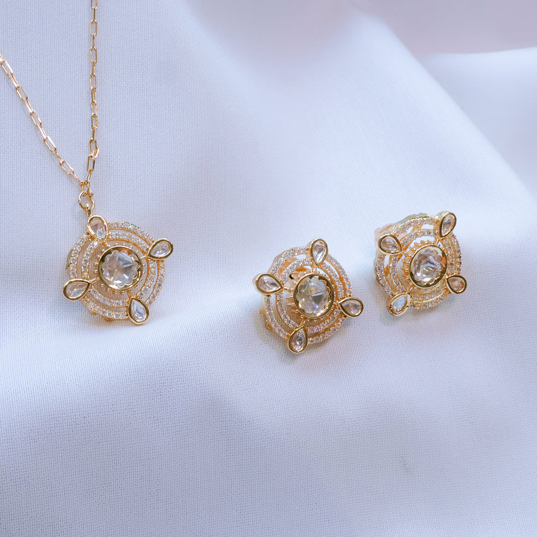 Gold jewelry set with necklace and earrings on a white background