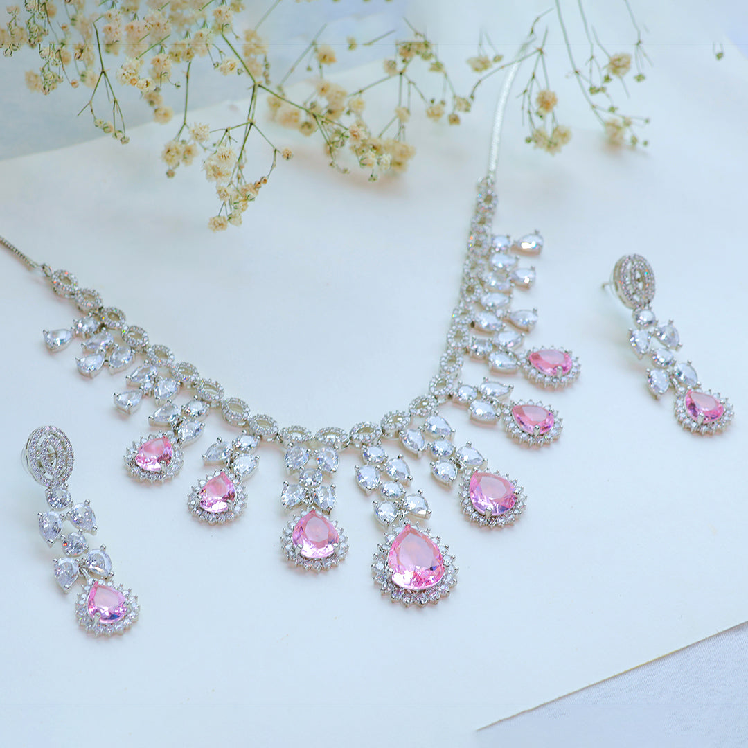 Jewelry set with pink gemstones on a light background
