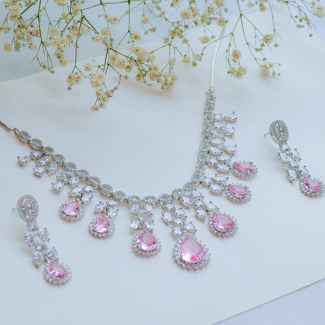 Jewelry set with pink gemstones on a light background
