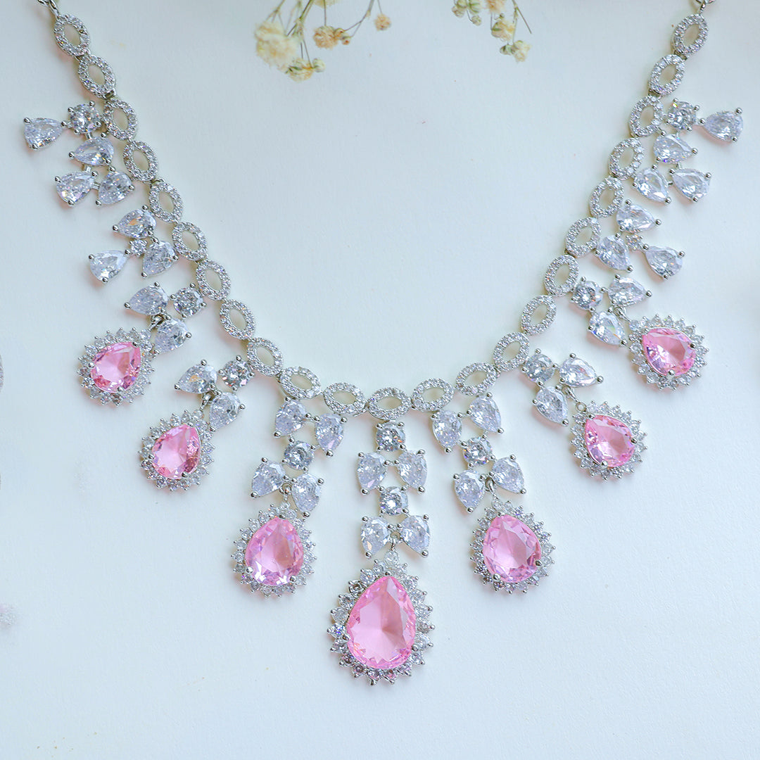 Necklace with pink and clear gemstones on a light background
