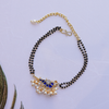 Handcrafted Double Layer Black Bead Hand Mangalsutra In Paachi Kundan Bird Charm