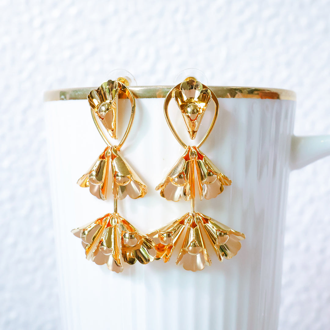 Gold earrings on a white background