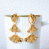 Gold earrings on a white background