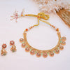 Gold necklace with floral designs and matching earrings on a light background