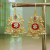 Ornate gold earrings with red center and pearl accents on a gold stand.
