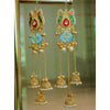 Ornate gold earrings with pearls and colorful stones on a reflective surface.