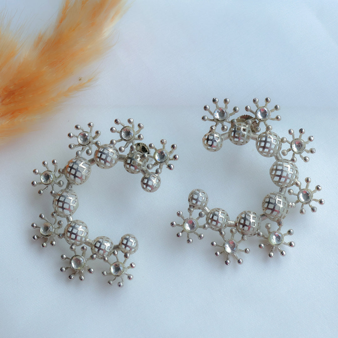 Silver bracelet with star-shaped beads on a white background